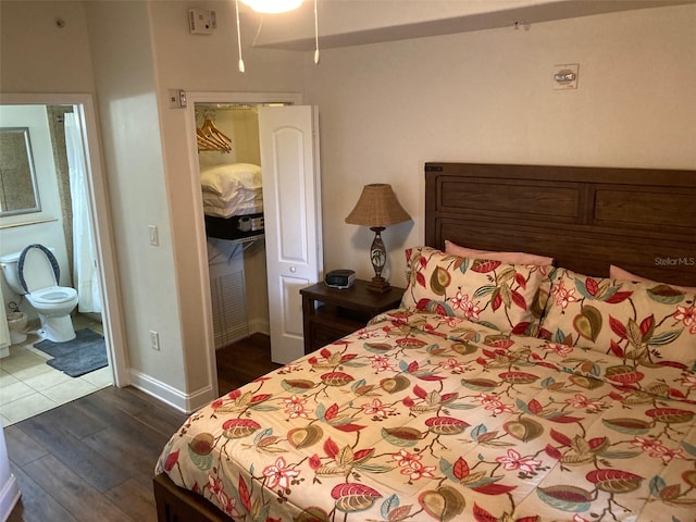 13415 Blue Heron Bch Unit 203, Orlando, FL 32821 - bedroom featuring dark wood-style flooring, ensuite bathroom, and a closet