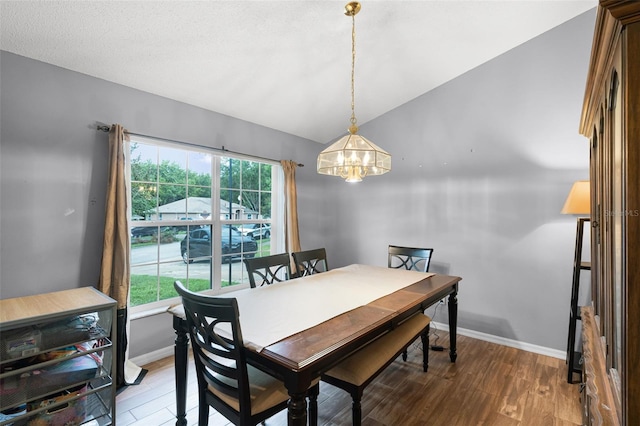 1113 Canopy Oaks Dr, Minneola, FL 34715 - dining room featuring a chandelier, light wood-style flooring, and lofted ceiling