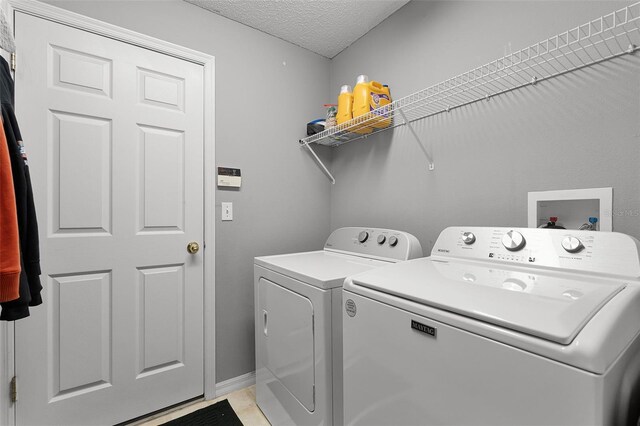 1113 Canopy Oaks Dr, Minneola, FL 34715 - washroom featuring washing machine and dryer and a textured ceiling