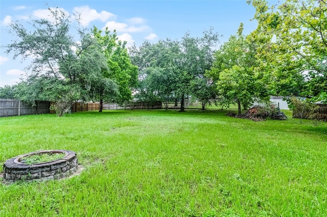1113 Canopy Oaks Dr, Minneola, FL 34715 - fenced backyard with a fire pit