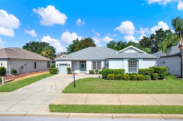 25105 Laurel Valley Rd, Leesburg, FL 34748 - ranch-style home featuring driveway, an attached garage, a front yard, stucco siding, and a shingled roof