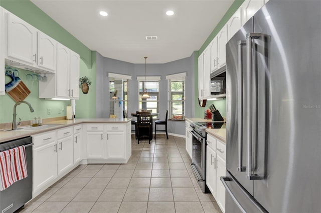 25105 Laurel Valley Rd, Leesburg, FL 34748 - kitchen featuring high end appliances, white cabinets, light tile patterned floors, and recessed lighting