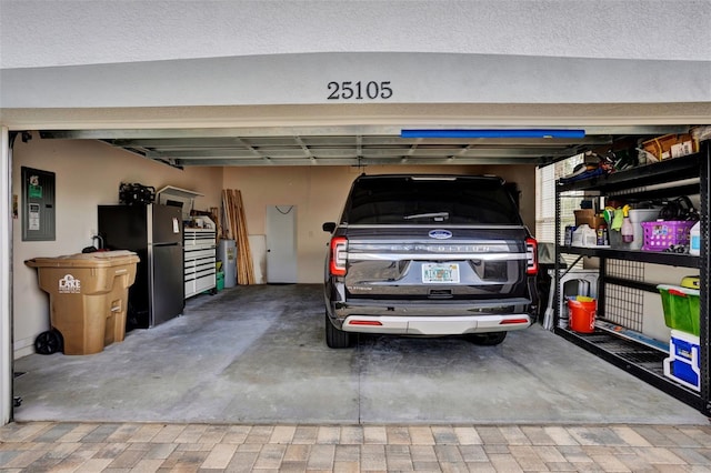 25105 Laurel Valley Rd, Leesburg, FL 34748 - garage with freestanding refrigerator and electric panel