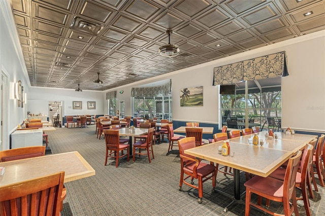 25105 Laurel Valley Rd, Leesburg, FL 34748 - carpeted dining room featuring an ornate ceiling, crown molding, and a wainscoted wall