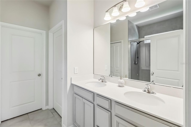 3142 Hill Point St, Minneola, FL 34715 - bathroom featuring tile patterned floors, double vanity, and an enclosed shower