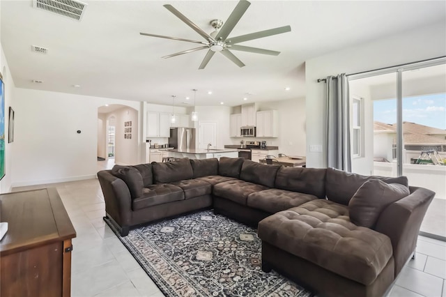 3142 Hill Point St, Minneola, FL 34715 - living room with arched walkways and a ceiling fan