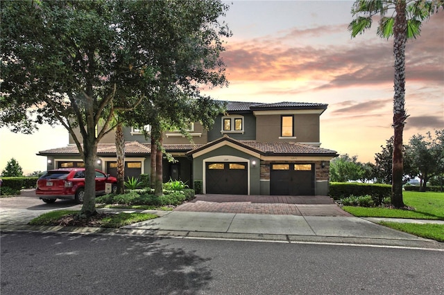 1269 Long Cove Loop Unit 1269, Davenport, FL 33896 - mediterranean / spanish home with a tile roof, a garage, driveway, and stucco siding