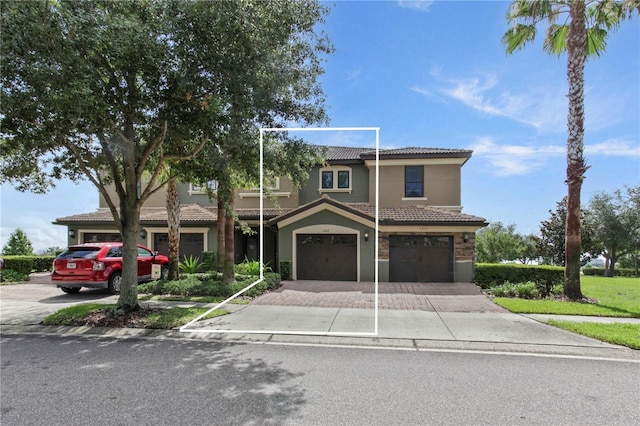 1269 Long Cove Loop Unit 1269, Davenport, FL 33896 - view of property with an attached garage, a tile roof, driveway, and stucco siding