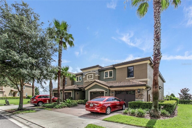 1269 Long Cove Loop Unit 1269, Davenport, FL 33896 - view of front facade with stone siding, a garage, driveway, stucco siding, and a tiled roof
