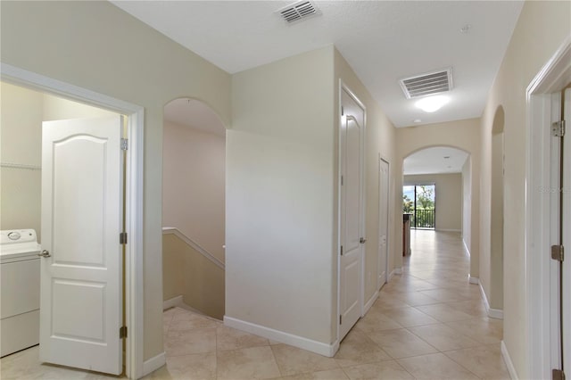 1269 Long Cove Loop Unit 1269, Davenport, FL 33896 - hallway with arched walkways, washer / clothes dryer, and light tile patterned floors