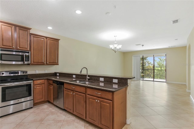 1269 Long Cove Loop Unit 1269, Davenport, FL 33896 - kitchen with stainless steel appliances, a peninsula, light tile patterned floors, a chandelier, and recessed lighting