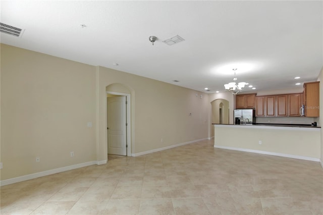 1269 Long Cove Loop Unit 1269, Davenport, FL 33896 - unfurnished living room with arched walkways, recessed lighting, and a chandelier