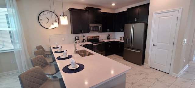 1201 Challenge Dr, Davenport, FL 33896 - kitchen featuring appliances with stainless steel finishes, light marble finish flooring, a peninsula, light countertops, and recessed lighting