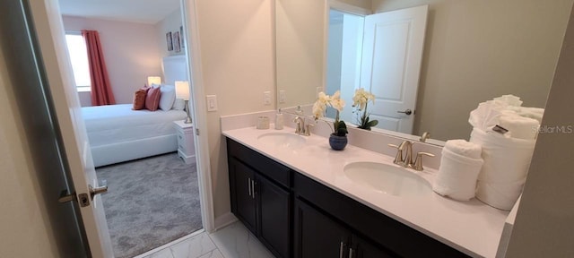 1201 Challenge Dr, Davenport, FL 33896 - ensuite bathroom featuring double vanity and marble look tiles