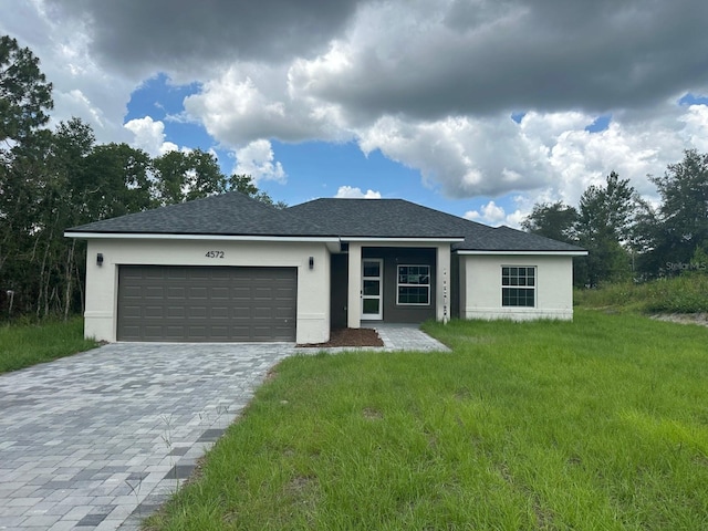 4572 SW 149th St, Ocala, FL 34473 - view of front of property featuring stucco siding, a garage, decorative driveway, and a front yard