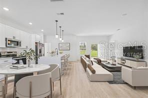 4572 SW 149th St, Ocala, FL 34473 - living room with light wood-style flooring and recessed lighting