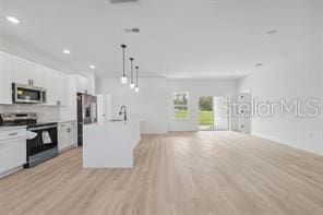 4572 SW 149th St, Ocala, FL 34473 - kitchen featuring stainless steel appliances, open floor plan, light wood-style floors, recessed lighting, and white cabinetry