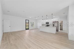 4572 SW 149th St, Ocala, FL 34473 - unfurnished living room featuring light wood-style flooring