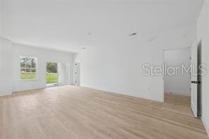 4572 SW 149th St, Ocala, FL 34473 - unfurnished living room with light wood-type flooring