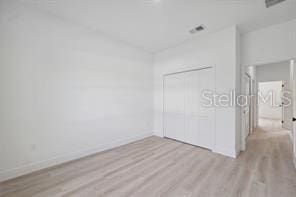 4572 SW 149th St, Ocala, FL 34473 - unfurnished bedroom featuring wood finished floors and a closet
