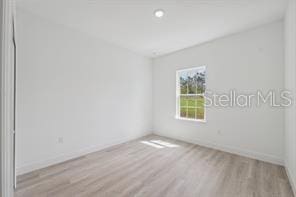 4572 SW 149th St, Ocala, FL 34473 - empty room with wood finished floors and baseboards