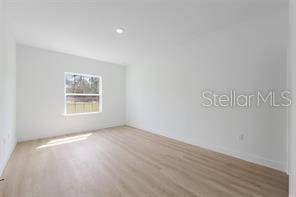 4572 SW 149th St, Ocala, FL 34473 - spare room with wood finished floors