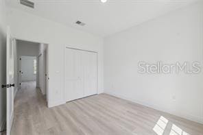 4572 SW 149th St, Ocala, FL 34473 - unfurnished bedroom with light wood-style flooring and a closet