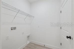 4572 SW 149th St, Ocala, FL 34473 - laundry area featuring light wood finished floors and hookup for a washing machine