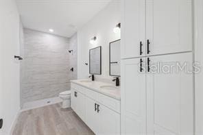 4572 SW 149th St, Ocala, FL 34473 - bathroom featuring tiled shower, double vanity, and wood finished floors
