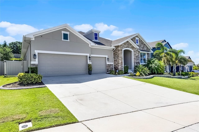 17290 Hickory Wind Dr, Clermont, FL 34711 - view of front of property with stone siding, stucco siding, concrete driveway, and an attached garage