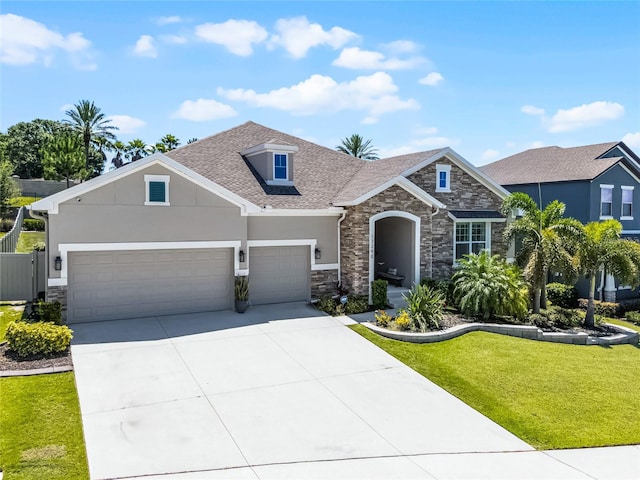 17290 Hickory Wind Dr, Clermont, FL 34711 - craftsman inspired home featuring stone siding, a front lawn, driveway, and stucco siding