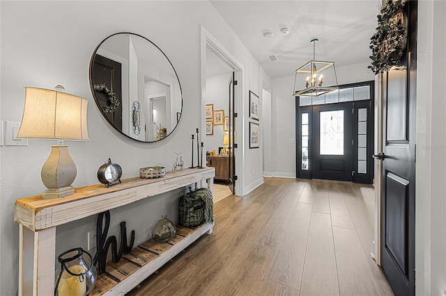 17290 Hickory Wind Dr, Clermont, FL 34711 - entrance foyer with a chandelier and wood finished floors
