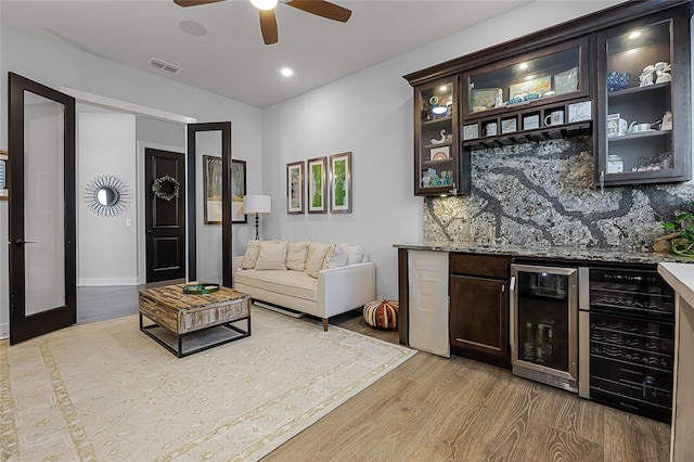 17290 Hickory Wind Dr, Clermont, FL 34711 - indoor dry bar with wine cooler, light wood-type flooring, backsplash, a ceiling fan, and recessed lighting