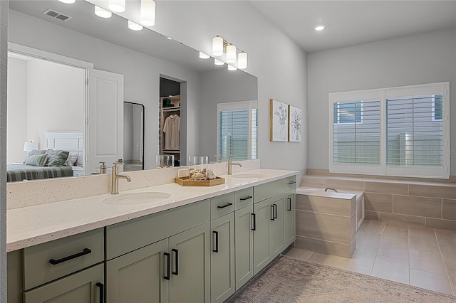 17290 Hickory Wind Dr, Clermont, FL 34711 - full bath featuring tile patterned flooring, double vanity, a bath, connected bathroom, and recessed lighting