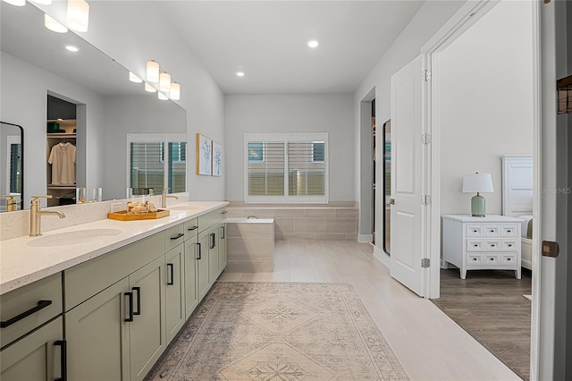 17290 Hickory Wind Dr, Clermont, FL 34711 - full bath featuring double vanity, recessed lighting, a bath, and a walk in closet