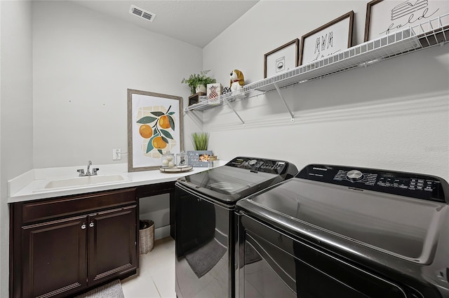 17290 Hickory Wind Dr, Clermont, FL 34711 - washroom with washer and clothes dryer, cabinet space, and light tile patterned floors