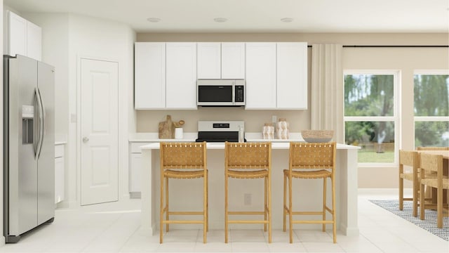 431 Puma Loop, Groveland, FL 34736 - kitchen with white appliances, white cabinets, light countertops, and a kitchen bar