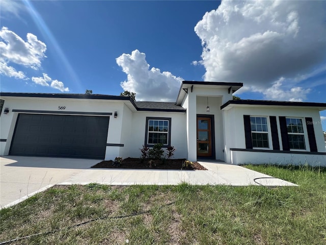 569 Marion Oaks Mnr, Ocala, FL 34473 - view of front of house featuring stucco siding, a garage, and driveway