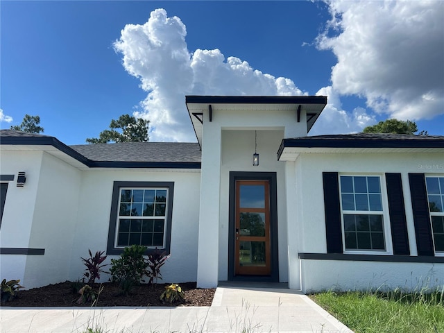 569 Marion Oaks Mnr, Ocala, FL 34473 - property entrance with stucco siding and roof with shingles