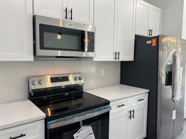 569 Marion Oaks Mnr, Ocala, FL 34473 - kitchen featuring appliances with stainless steel finishes and white cabinets