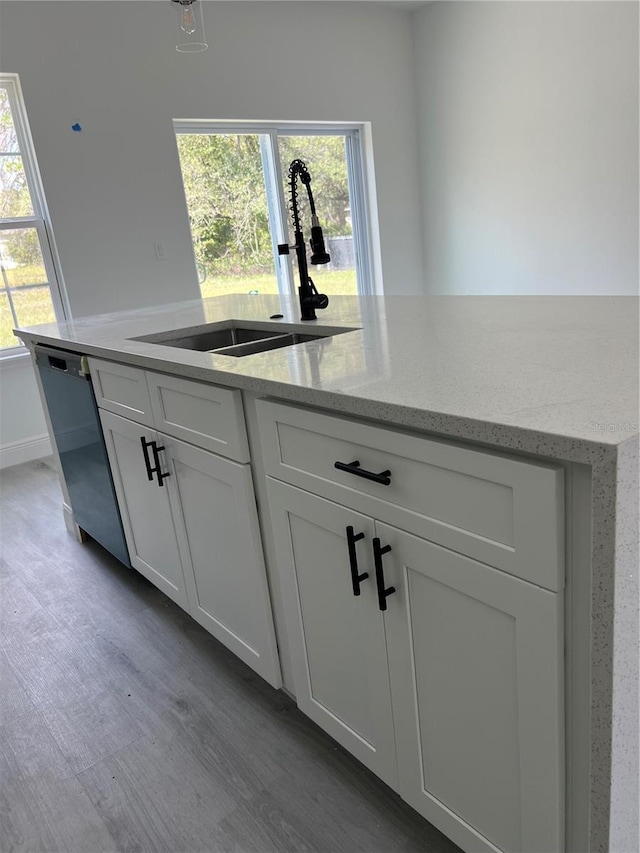 569 Marion Oaks Mnr, Ocala, FL 34473 - kitchen with dishwasher, white cabinetry, wood finished floors, and light stone countertops