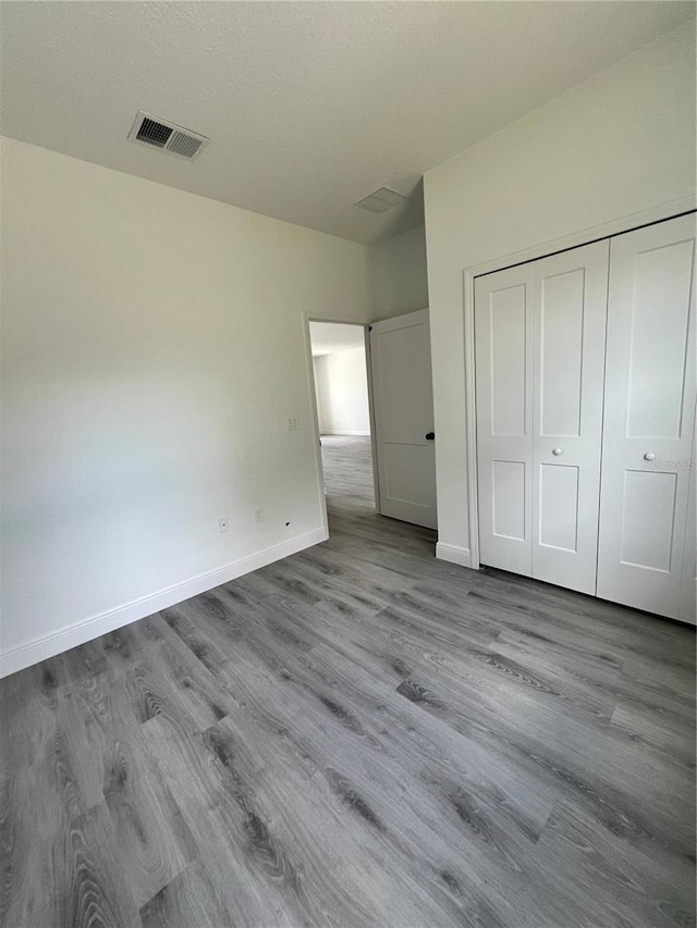 569 Marion Oaks Mnr, Ocala, FL 34473 - unfurnished bedroom featuring wood finished floors and a closet