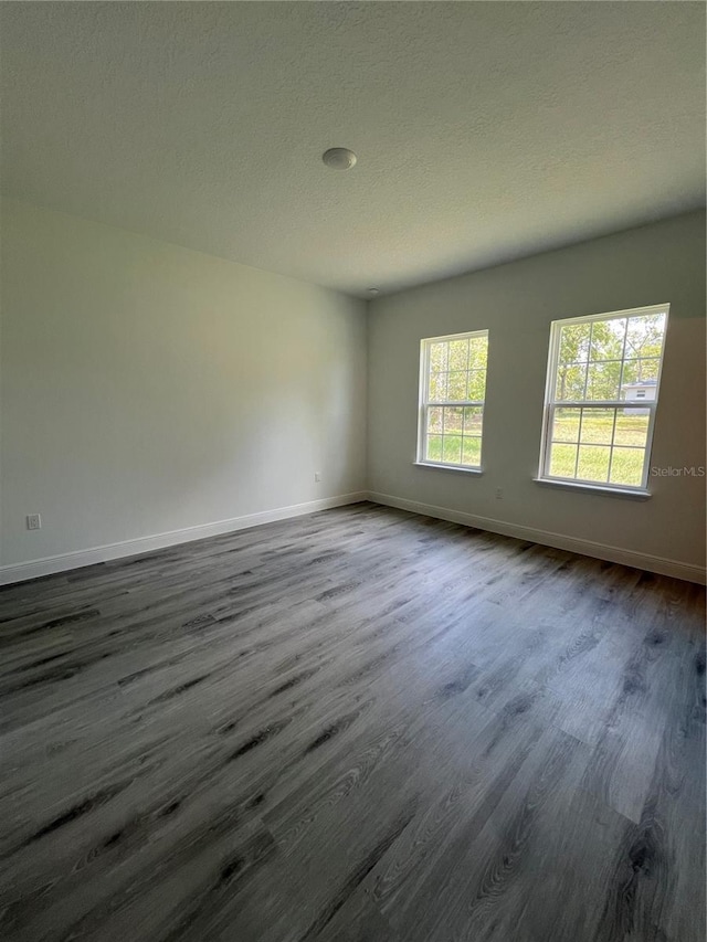 569 Marion Oaks Mnr, Ocala, FL 34473 - spare room with dark wood-type flooring and a textured ceiling
