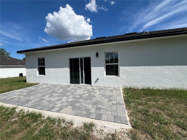 569 Marion Oaks Mnr, Ocala, FL 34473 - back of house with a patio area and stucco siding