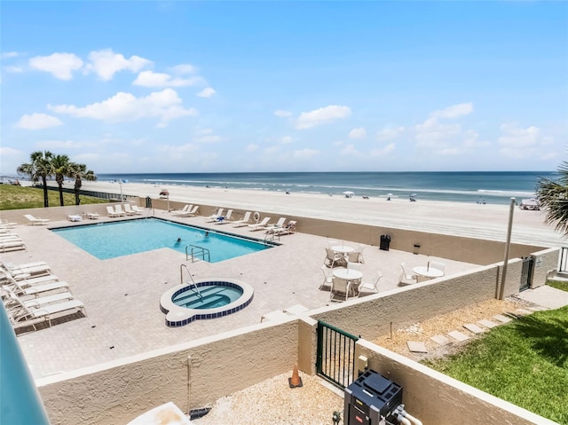 4631 S Atlantic Ave Unit 8102, Port Orange, FL 32127 - community pool with a hot tub, a patio area, and view of water and beach