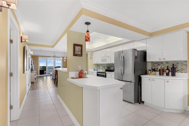 4631 S Atlantic Ave Unit 8102, Port Orange, FL 32127 - kitchen with stainless steel appliances, backsplash, light countertops, white cabinets, and light tile patterned floors