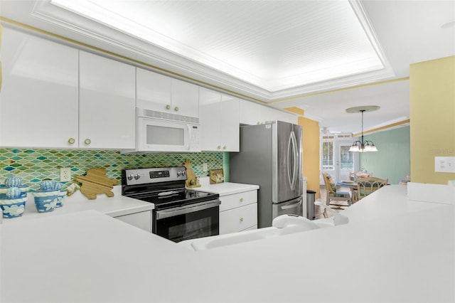4631 S Atlantic Ave Unit 8102, Port Orange, FL 32127 - kitchen featuring appliances with stainless steel finishes, white cabinets, light countertops, and ornamental molding