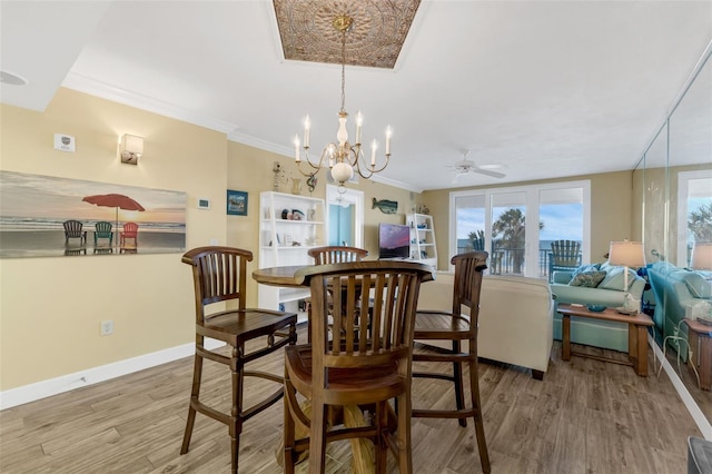 4631 S Atlantic Ave Unit 8102, Port Orange, FL 32127 - dining area with a chandelier, wood finished floors, crown molding, and a ceiling fan