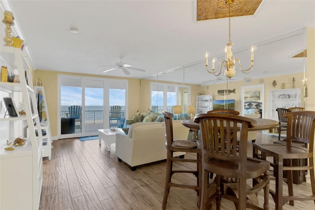 4631 S Atlantic Ave Unit 8102, Port Orange, FL 32127 - dining space featuring a ceiling fan, wood finished floors, and a chandelier