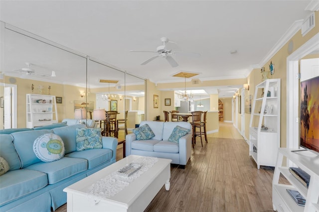 4631 S Atlantic Ave Unit 8102, Port Orange, FL 32127 - living area featuring ceiling fan, ornamental molding, a chandelier, and wood finished floors